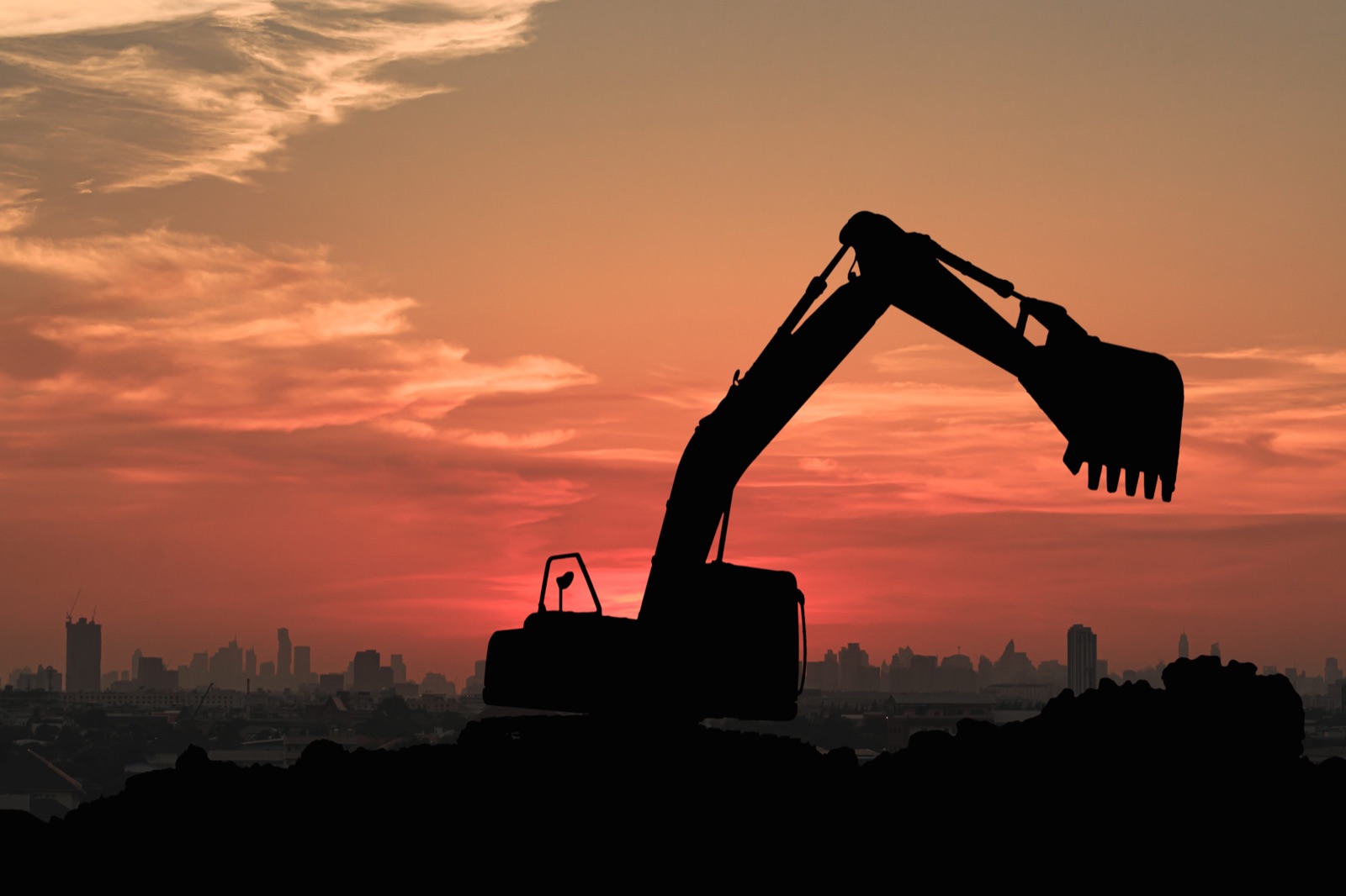 Excavators on a construction site at sunset